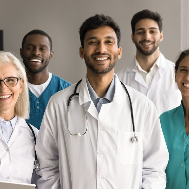 group of doctors and nurses smiling 